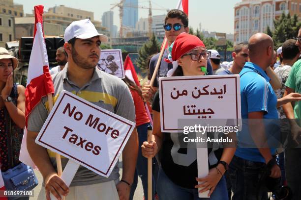 Protesters gather at Riad Al Solh Square to protest against the proposed new tax plans and the wage increases in the Lebanese parliament, in Beirut,...