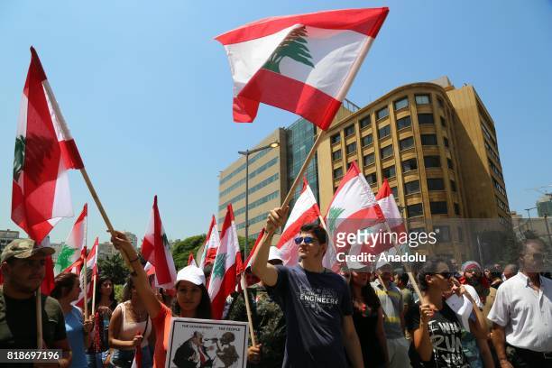 Protesters gather at Riad Al Solh Square to protest against the proposed new tax plans and the wage increases in the Lebanese parliament, in Beirut,...