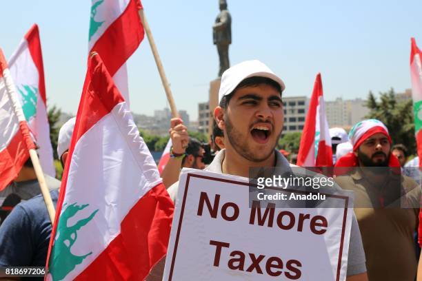 Protesters gather at Riad Al Solh Square to protest against the proposed new tax plans and the wage increases in the Lebanese parliament, in Beirut,...