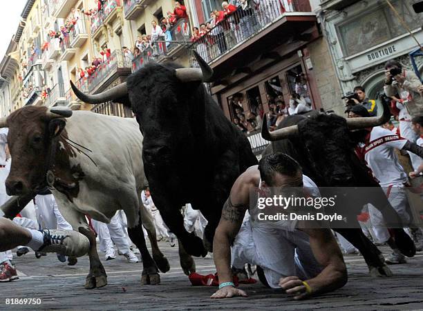 Fighting bull leaps over a fallen runner at the Mercaderes curve during the third San Fermin running of the bulls on July 9, 2008 in Pamplona, Spain....