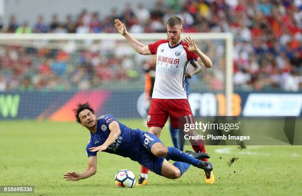 Shinji Okazaki of Leicester City is brought down by Chris Brunt of West Bromwich Albion during the Premier League Asia Trophy on July 19th , 2017 in...