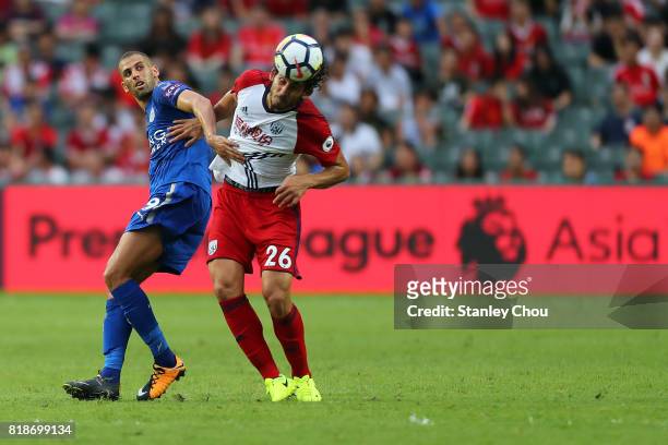Islam Slimani of Leiceister City holds off Ahmed Hegazy of West Bromwich Albion during the Premier League Asia Trophy match between Leicester City...