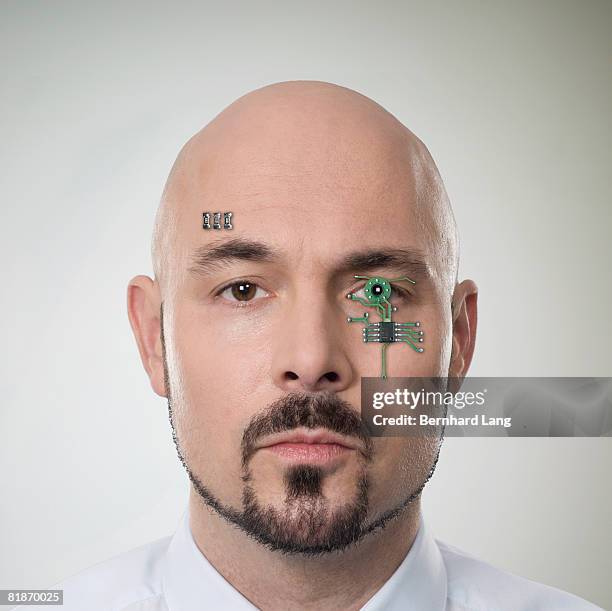 man with computer chip in face - cyborg eye stock pictures, royalty-free photos & images