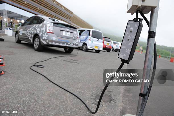 Latest Japanese hybrid cars using electricity and hydrogen are charged with power in a display of technology on clean energy and environment at the...