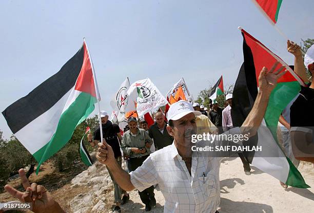 Palestinian demonstrators hold up their national flag during a protest marking the fourth anniversary since the International Court of Justice called...