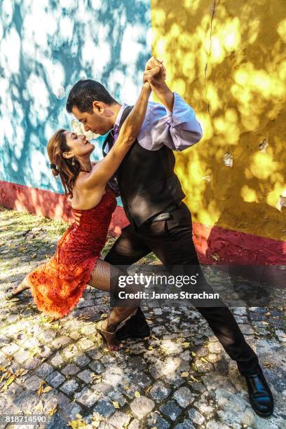 street tango dancers against colourful wall, el caminito, la boca, buenos aires (birthplace of the tango), argentina  (model released) - argentina tango stock pictures, royalty-free photos & images