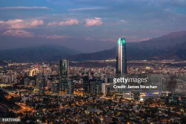night-time aerial view of the city including the torre santiago (tallest building in south america, 300m), from cerro san cristobal of santiago, chile - chile stock-fotos und bilder