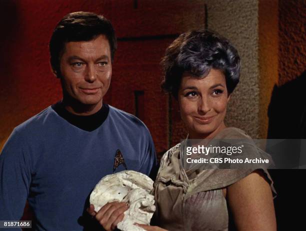 American actor DeForest Kelley as Dr. Leonard 'Bones' McCoy and American actress Jeanne Bal as Nancy Crater appear in a scene from 'The Man Trap,'...