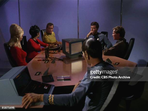 The crew of the Starship Enterprise sit around a table in a scene from 'The Man Trap,' the premiere episode of 'Star Trek,' which aired on September...