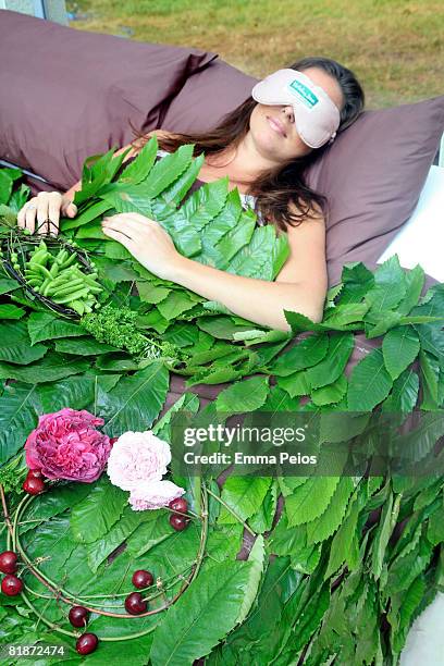 Model poses in an edible bed during the Hampton Court Palace Flower Show on July 7, 2008 in Richmond-upon-Thames, England.