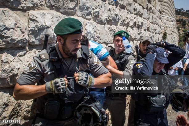 Palestinian Muslims clash outside the entrance to the old city of Jerusalem as it is partially blocked by Israeli Police on July 19, 2017 in...