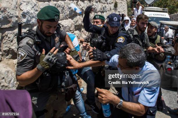 Palestinian Muslims clash outside the entrance to the old city of Jerusalem as it is partially blocked by Israeli Police on July 19, 2017 in...