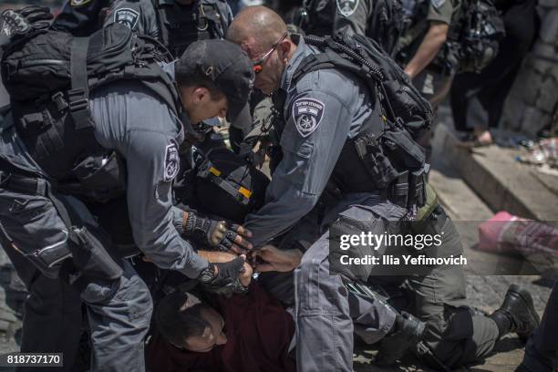 Palestinian Muslims clash outside the entrance to the old city of Jerusalem as it is partially blocked by Israeli Police on July 19, 2017 in...