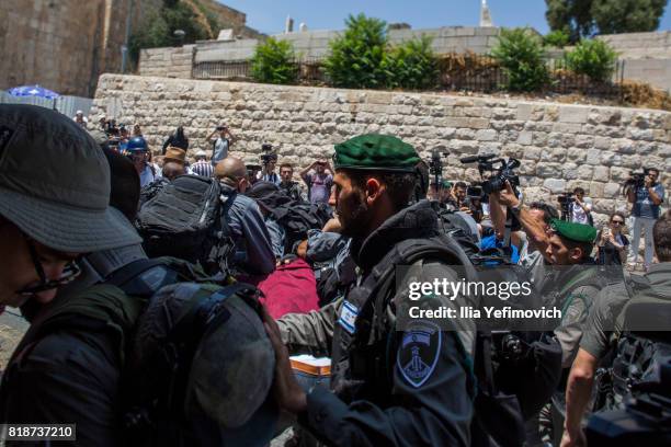 Palestinian Muslims clash outside the entrance to the old city of Jerusalem as it is partially blocked by Israeli Police on July 19, 2017 in...