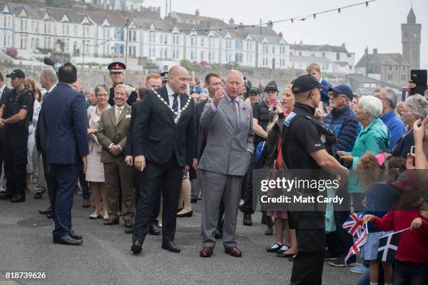 Prince Charles, Prince of Wales meets members of the public as he visits Porthleven during an annual trip to Devon and Cornwall on July 19, 2017 in...