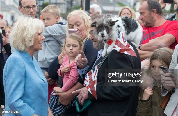 Camilla, Duchess of Cornwall greets Sophie, a three year old Jack Russell Terrier owned by Peter Hichens from Porthleven as he visits Porthleven...