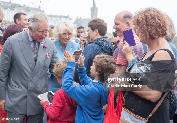 Prince Charles, Prince of Wales and Camilla, Duchess of Cornwall, meet members of the public as they visit Porthleven during an annual trip to Devon...