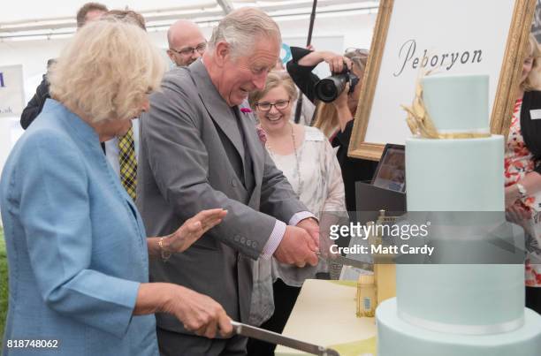 Prince Charles, Prince of Wales and Camilla, Duchess of Cornwall, cut lemon and Cornish elderflower sponge cakes, one of Highgrove House and the...