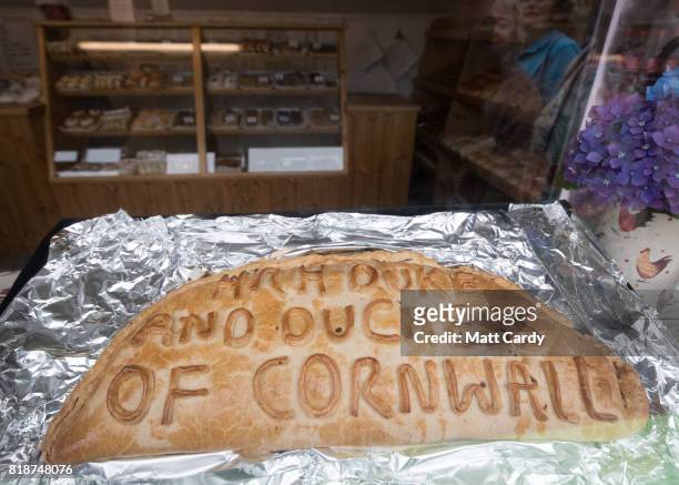 Pasty is displayed in the window of a bakery as Prince Charles, Prince of Wales and Camilla, Duchess of Cornwall visit Porthleven during an annual...