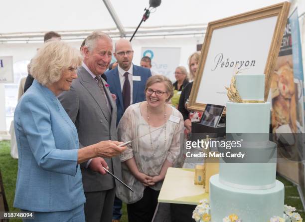 Prince Charles, Prince of Wales and Camilla, Duchess of Cornwall, cut lemon and Cornish elderflower sponge cakes, one of Highgrove House and the...