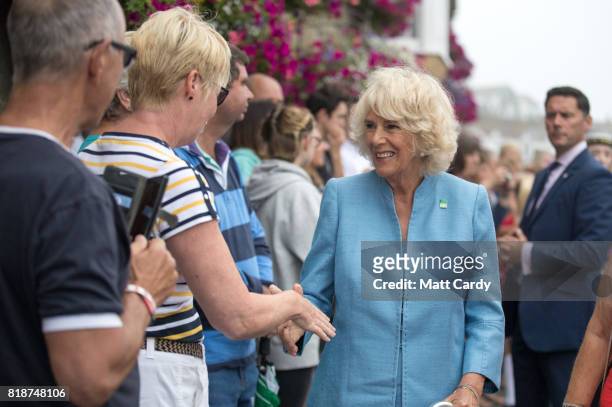 Camilla, Duchess of Cornwall, meets members of the public as she visits Porthleven during an annual trip to Devon and Cornwall on July 19, 2017 in...