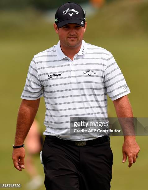 Golfer Patrick Reed walks on the 9th green during a practice round at Royal Birkdale golf course near Southport in north west England on July 19...