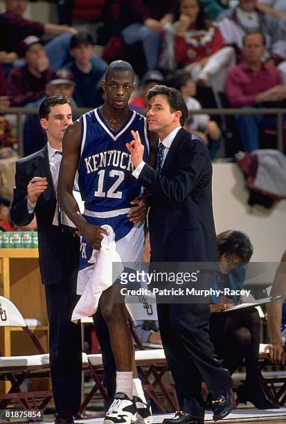 College Basketball: Kentucky coach Rick Pitino talking with Rodrick Rhodes on sidelines during game vs Mississippi State, Starkville, MS 1/22/1994