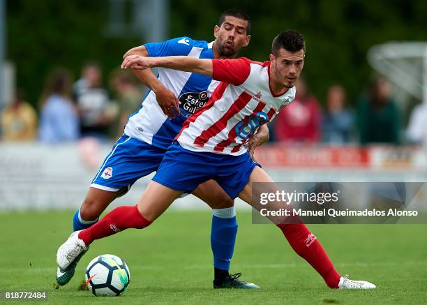 Juanfran Moreno of Deportivo de La Coruna competes for the ball with Cani of Cerceda during the pre-season friendly match between Cerceda and...