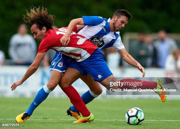 Edu Exposito of Deportivo de La Coruna competes for the ball with Carlos of Cerceda during the pre-season friendly match between Cerceda and...