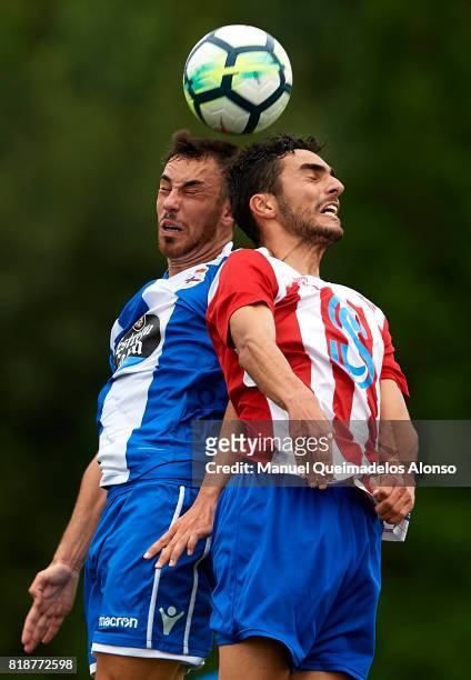 Edu Exposito of Deportivo de La Coruna competes for the ball with Pedrosa of Cerceda during the pre-season friendly match between Cerceda and...