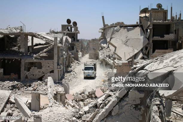 Truck drives down a destroyed street in a rebel-held area in Daraa on July 19 as civilians started to return to the area following the July 9...