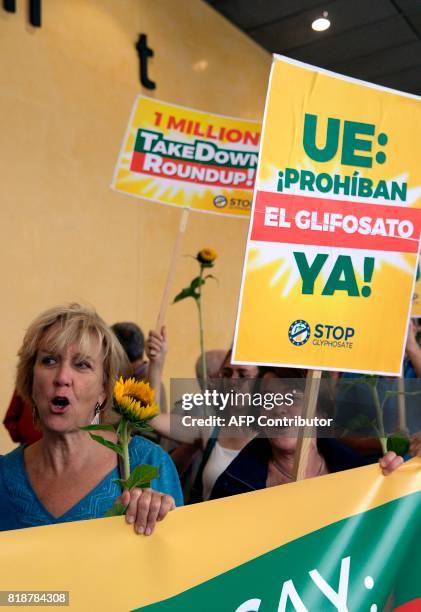 Activists hold signs as they demonstrate in favor of a Glyphosate ban by the European Union in front of the European Union Commission headquarter in...