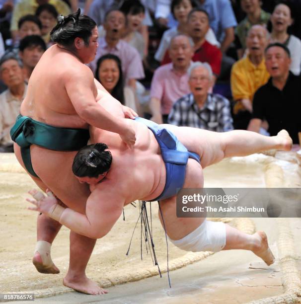 Nishikigi throws Bulgarian wreslter Aoiyama to win during day eleven of the Grand Sumo Nagoya Torunament at Aichi Prefecture Gymnasium on July 19,...