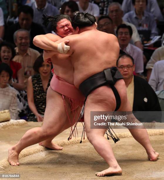 Ozeki Goeido pushes Ura out of the ring to win during day eleven of the Grand Sumo Nagoya Torunament at Aichi Prefecture Gymnasium on July 19, 2017...