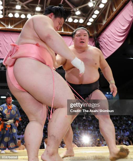 Ozeki Goeido pushes Ura out of the ring to win during day eleven of the Grand Sumo Nagoya Torunament at Aichi Prefecture Gymnasium on July 19, 2017...