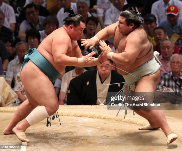 Mongolian sekiwake Tamawashi pushes ozeki Takayasu out of the ring to win during day eleven of the Grand Sumo Nagoya Torunament at Aichi Prefecture...