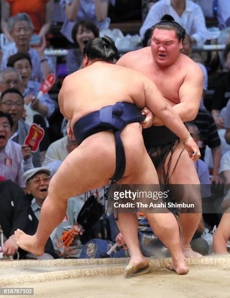 Sekiwake Mitakeumi pushes Mongolian yokozuna Hakuho out of the ring to win during day eleven of the Grand Sumo Nagoya Torunament at Aichi Prefecture...