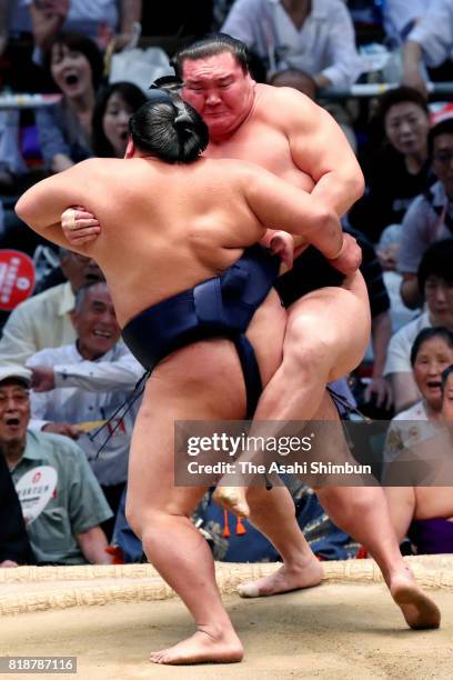 Sekiwake Mitakeumi pushes Mongolian yokozuna Hakuho out of the ring to win during day eleven of the Grand Sumo Nagoya Torunament at Aichi Prefecture...