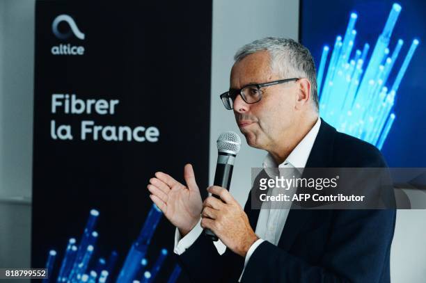 Telecom Company Altice NV group Chief Executive Officer and Chief Executive Officer of SFR Michel Combes gestures as he addresses a press conference...