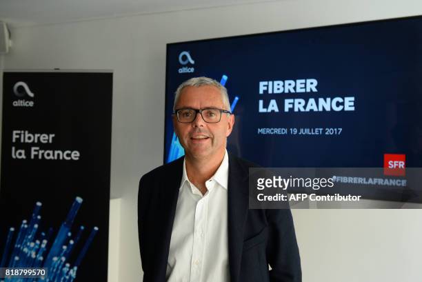 Telecom Company Altice NV group Chief Executive Officer and Chief Executive Officer of SFR Michel Combes poses prior to a press conference concerning...
