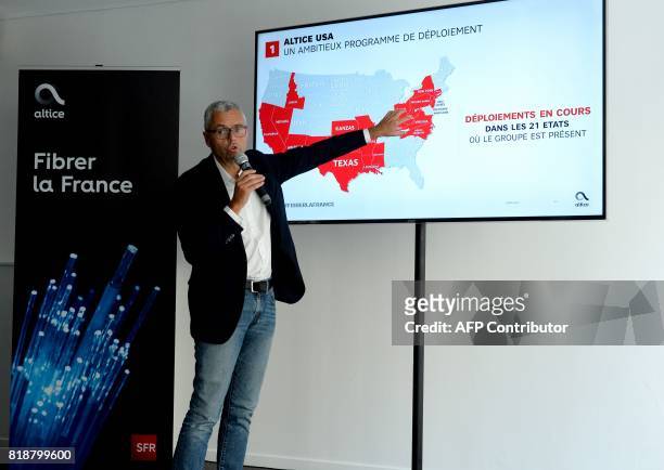 Telecom Company Altice NV group Chief Executive Officer and Chief Executive Officer of SFR Michel Combes gestures as he addresses a press conference...