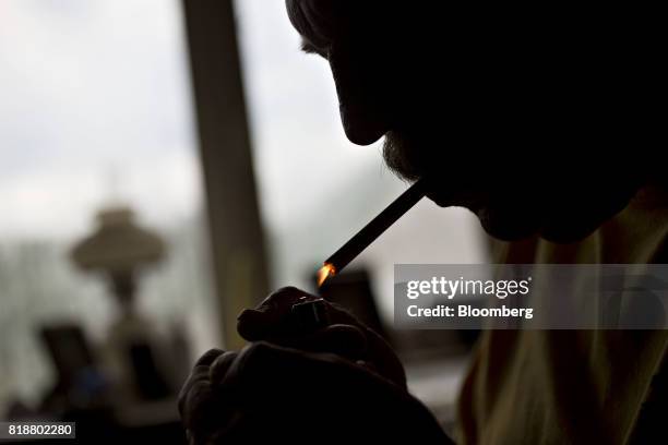 Man lights a Philip Morris Marlboro brand cigarette in Tiskilwa, Illinois, U.S., on Wednesday, July 12, 2017. Philip Morris International Inc. Is...