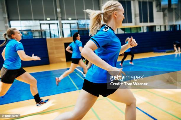 female handball team warming up - handball girl stock pictures, royalty-free photos & images