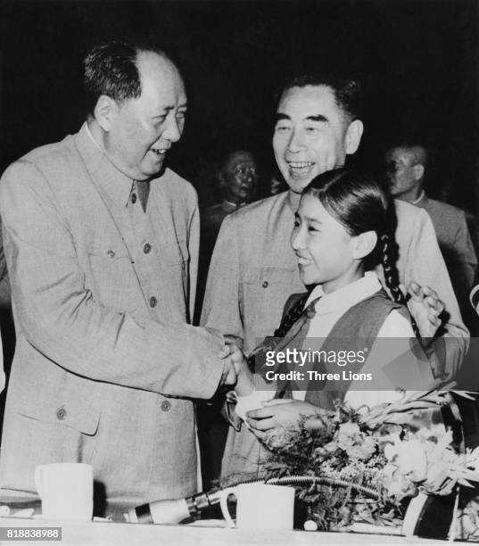 Chinese leader Mao Zedong and Zhou Enlai , Premier of the People's Republic of China, talk to a young girl in Peking, Beijing, 1961.