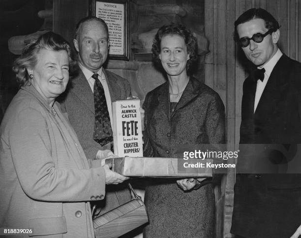 Priscilla Buchan, Baroness Tweedsmuir, the MP for South Aberdeen, is presented with a box of kippers by Sir John Craster at the House of Commons in...