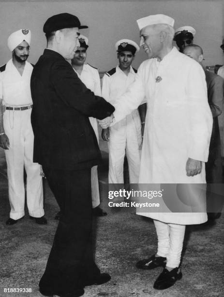 Zhou Enlai , Premier of the People's Republic of China, is greeted by Indian Prime Minister Jawaharlal Nehru at the Indian Air Force Station in...