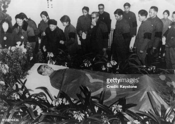 Zhou Enlai , Premier of the People's Republic of China, lies in state in a hospital in Peking , draped in the Communist flag, January 1976.