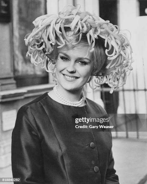 Lesley Langley, winner of the 1965 Miss World contest, models 'Prix de Diane', at the Christian Dior Chapeaux Spring Collection 1966 in London, 30th...