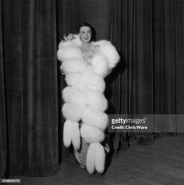 American entertainer Gypsy Rose Lee begins her act in white fox fur, Bristol, UK, 1951.