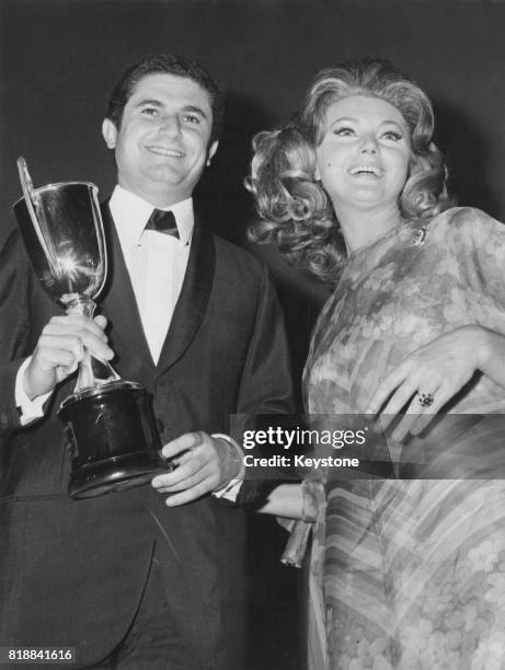 French film director Claude Lelouch receives an award from actress Sylva Koscina during the British Films Festival in Sorrento, Italy, September 1967.